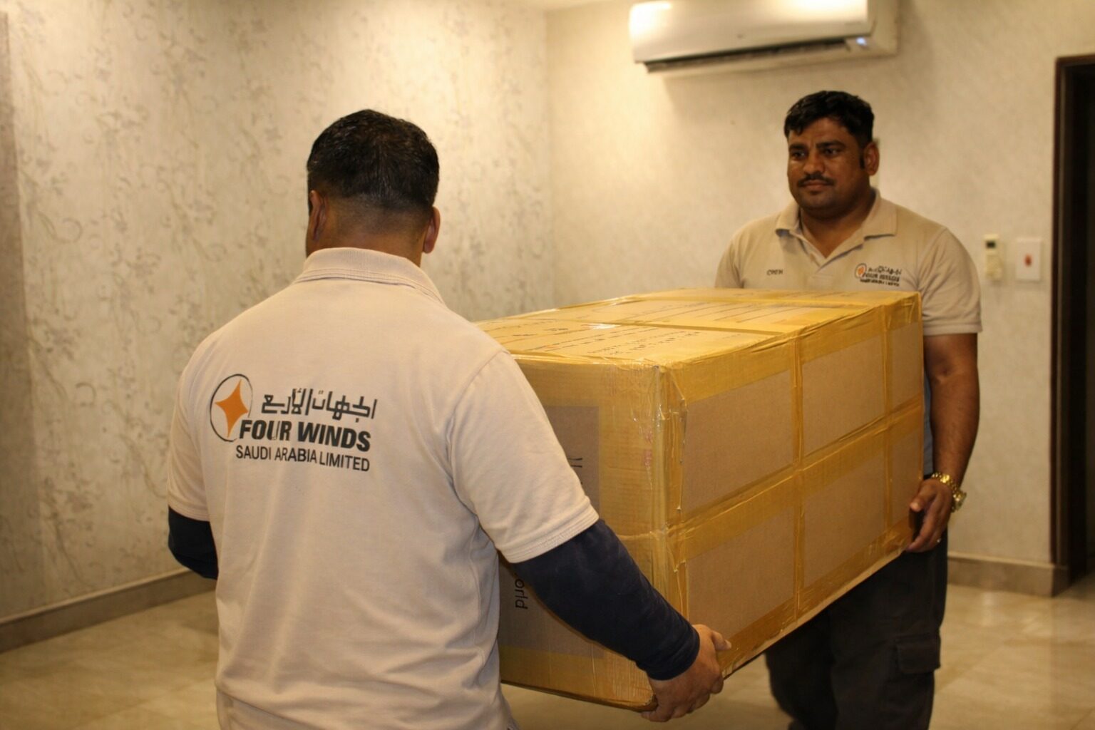 Four Winds Saudi Arabia movers carrying a professionally packed household item